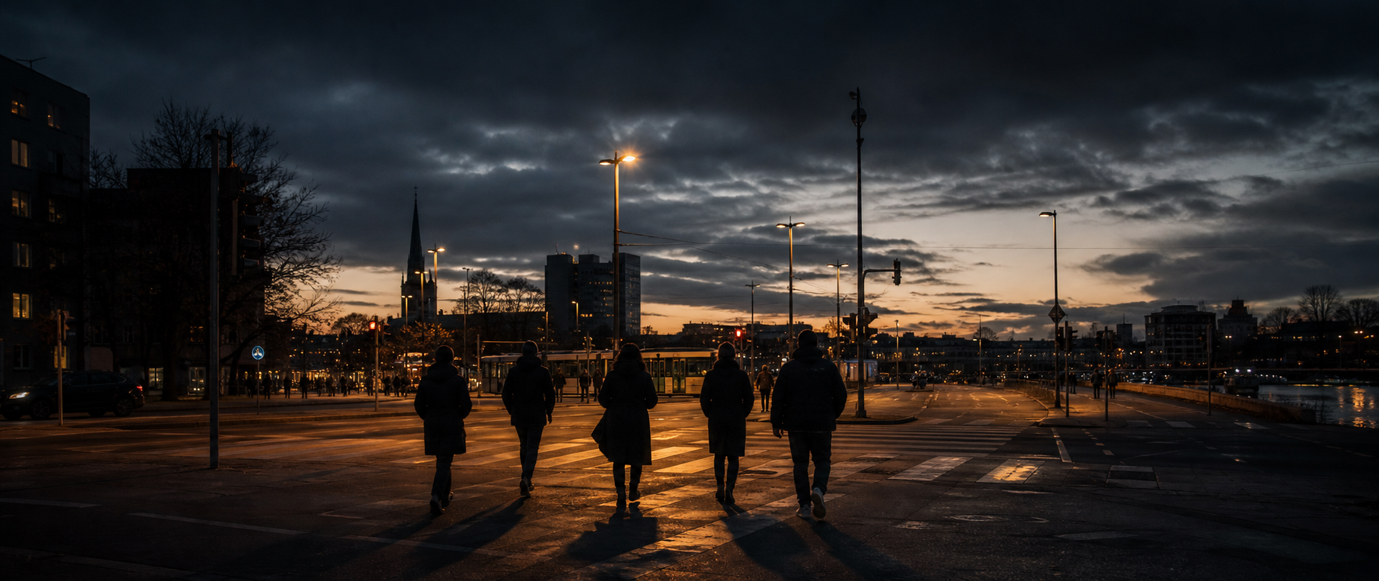 A small group walking through a European city at dusk
