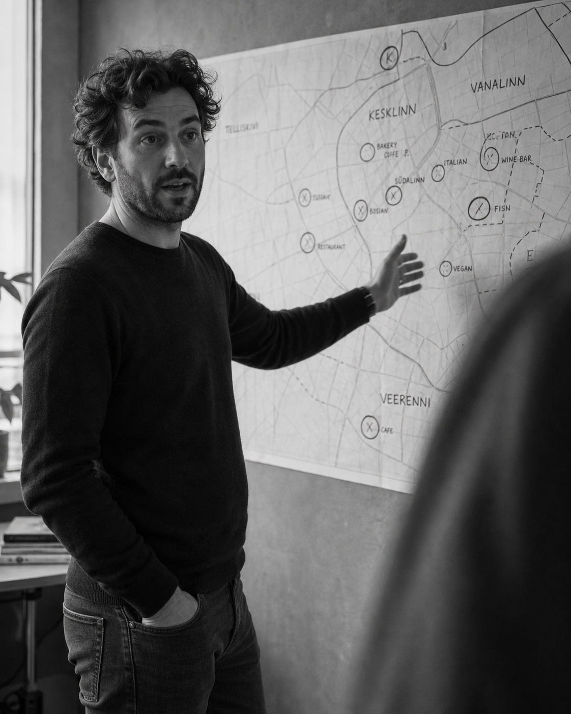 A founder mapping a city's neighborhoods on a workshop wall