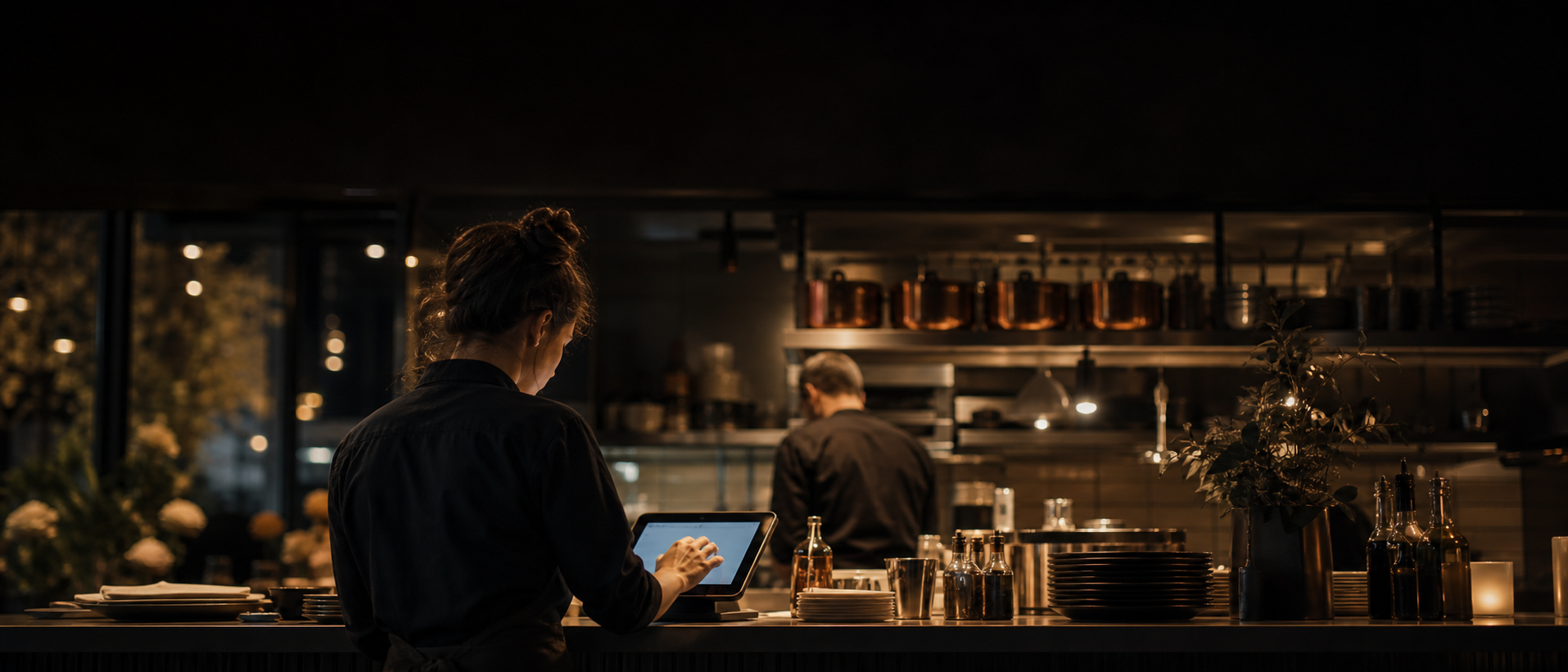 A server takes an order on a tablet inside a busy café — Kesk POS in real use